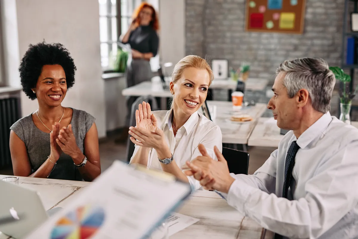 Team members collaborating in a bright meeting space